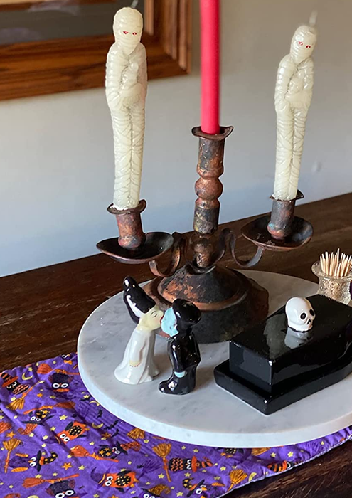 Frankenstein's monster and bride salt and pepper shakers displayed as the centerpiece of a reviewer's dining table
