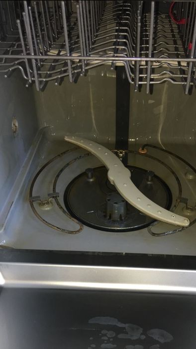The same dishwasher now spotless after using the cleaning tablets