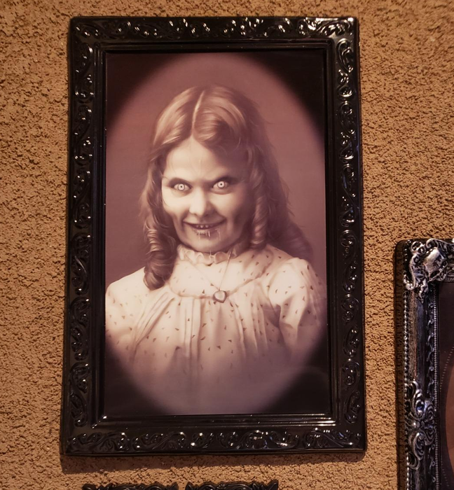 The same portrait viewed from another angle, revealing a more sinister expression on the little girl's face