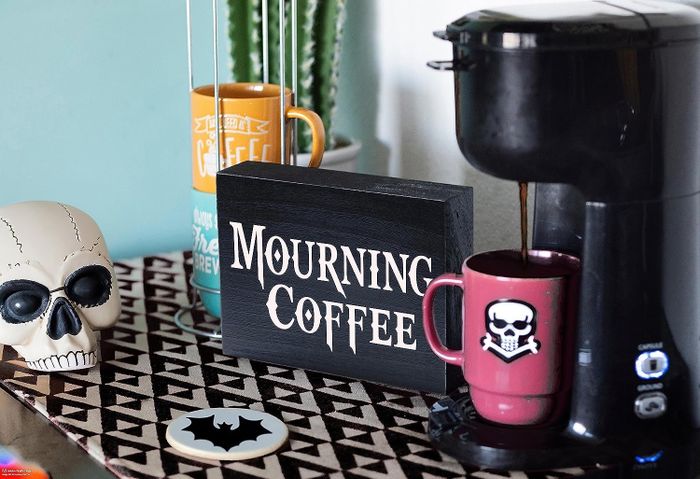 a black wooden sign reading