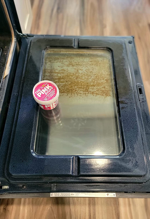 A reviewer's oven half-cleaned after using The Pink Stuff