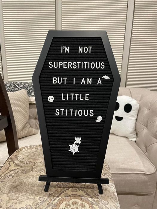 A black coffin-shaped letterboard