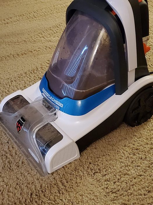 Close-up of the vacuum filled with dirt extracted from a reviewer's carpet