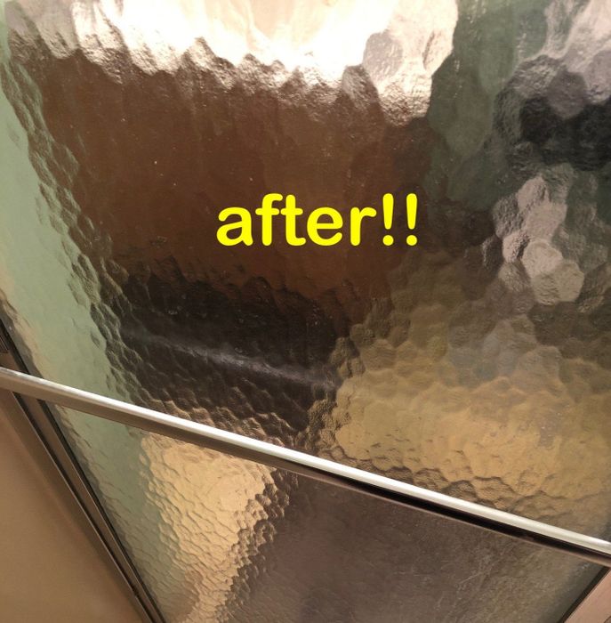 Same reviewer's after photo showing a completely clear shower door after using the treatment
