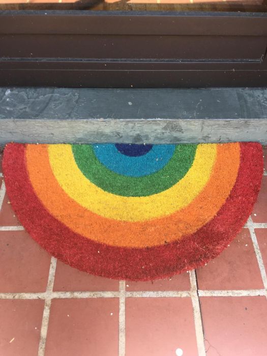 A vibrant rainbow door mat.
