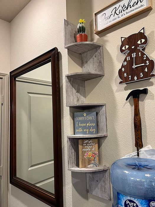 The gray shelf featuring a plant and canvas artwork