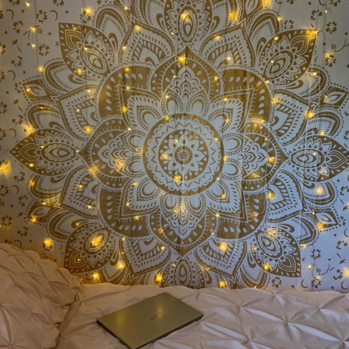 Lights suspended against a decorative tapestry