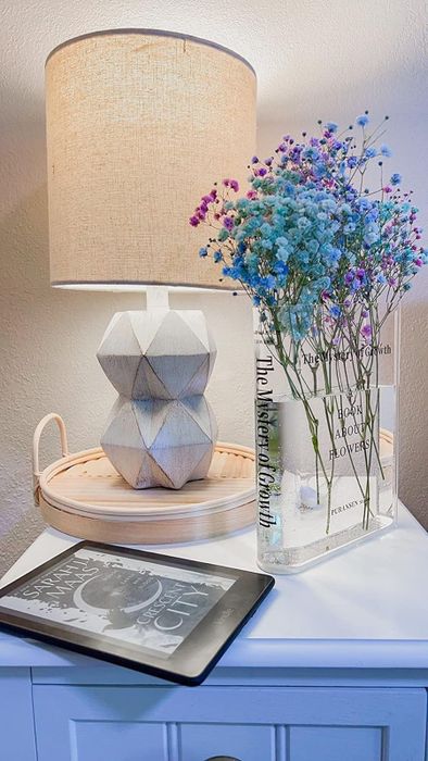 Blue and purple flowers arranged inside the clear vase