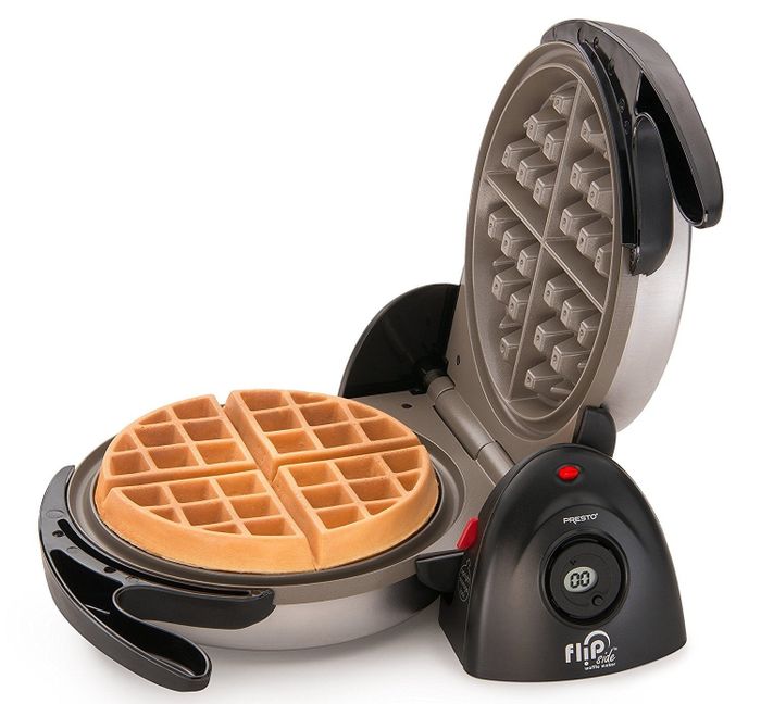 The waffle maker with a golden waffle inside, ready to be enjoyed.