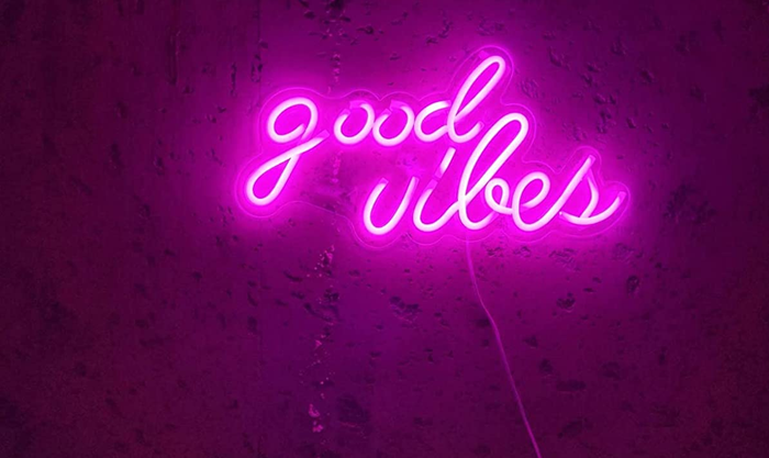 A close-up view of the neon sign glowing in vibrant pink