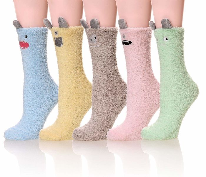 Five pairs of socks in a fun mix of colors — blue, yellow, tan, pink, and green — each featuring quirky ears and unique facial expressions.