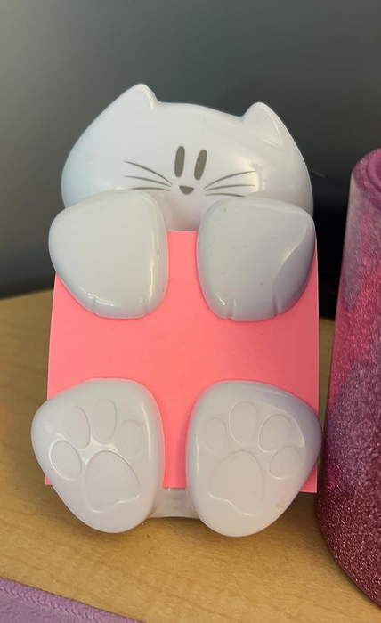 A photo of a reviewer showcasing the Post-It note holder
