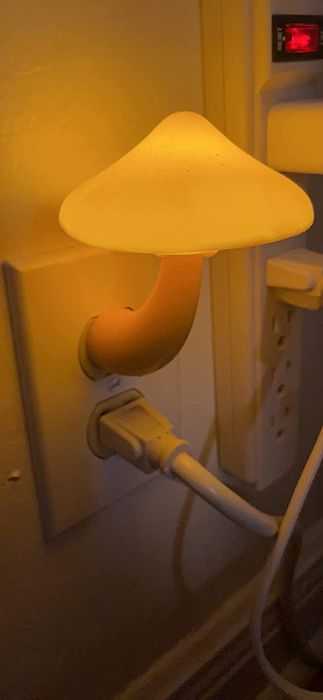 The white mushroom nightlight connected to an outlet