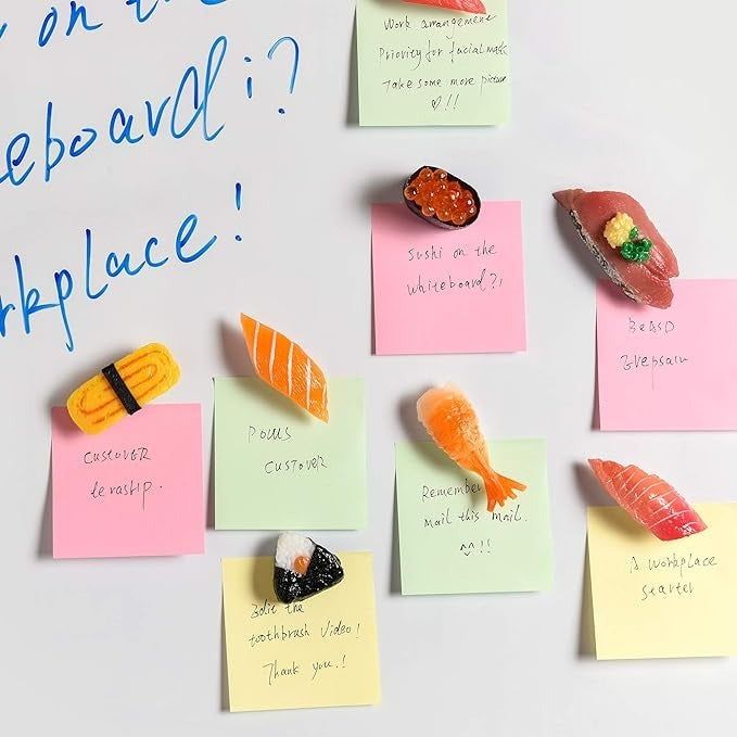 The magnets holding sticky notes on a whiteboard