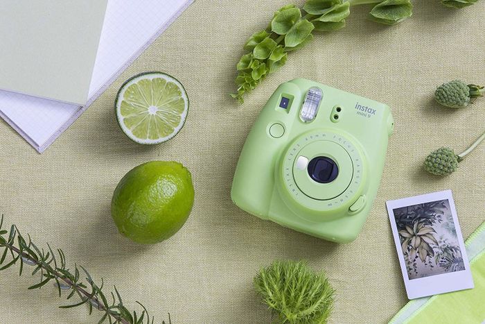 The light green camera alongside the rectangular photo it prints.
