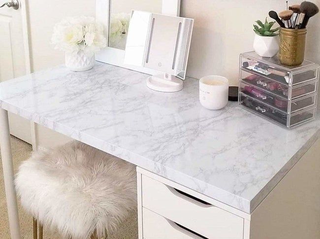 Faux white and granite covering a sleek white desk