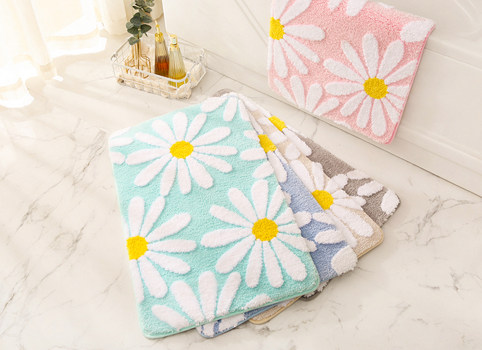 Daisy bath mats available in green, blue, beige, grey, and pink – offering a cheerful variety of colors to brighten up your bathroom.
