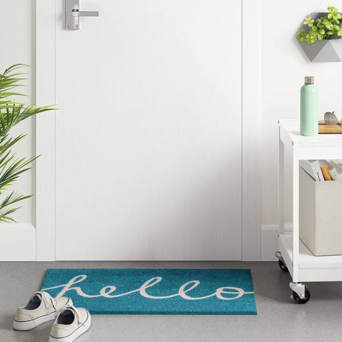 The doormat with the word “hello” written in cursive