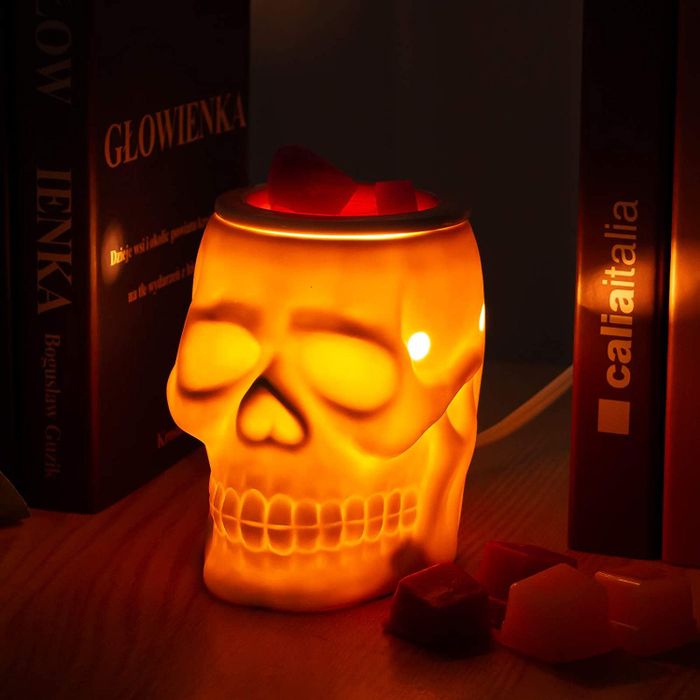 A skull-shaped light-up candle wax melt warmer