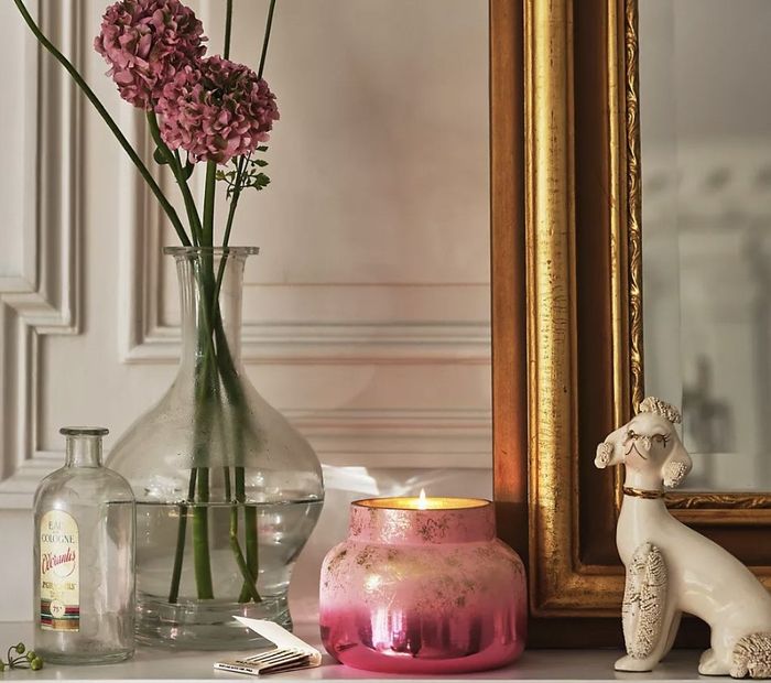 The pink candle gently flickering on the mantlepiece, casting a soft light.