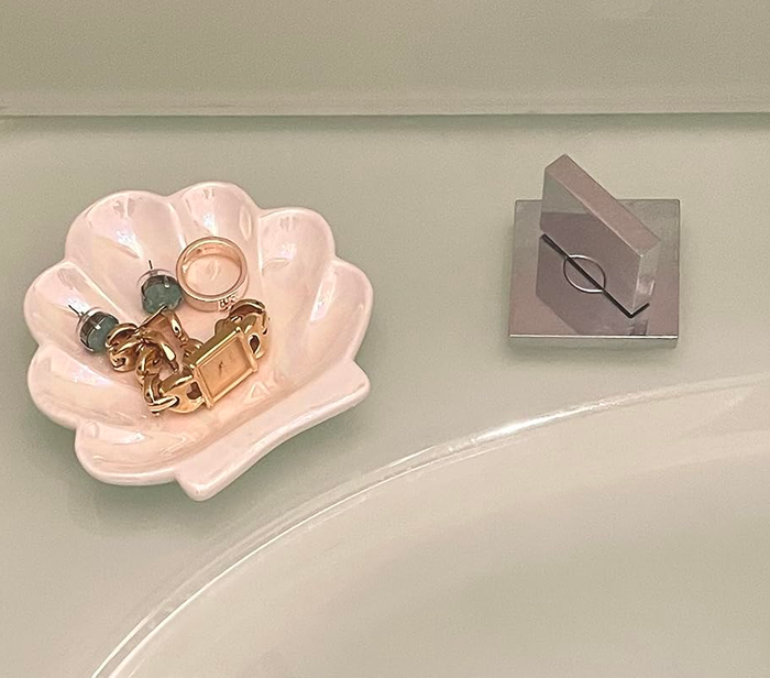 The same reviewer’s shell trinket dish, now placed beside a sink, adding a cute and functional touch to the space.