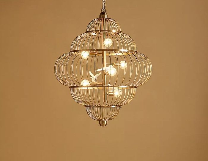 The chandelier hanging gracefully from the ceiling, casting its glow.