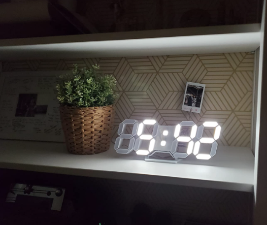A reviewer’s image showcasing the digital clock on a shelf