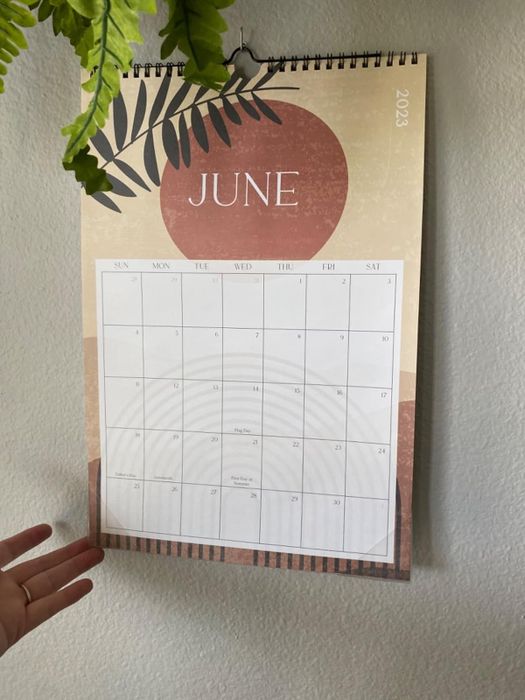A reviewer’s boho wall calendar, opened to the June page, adding a cheerful vibe to the room.