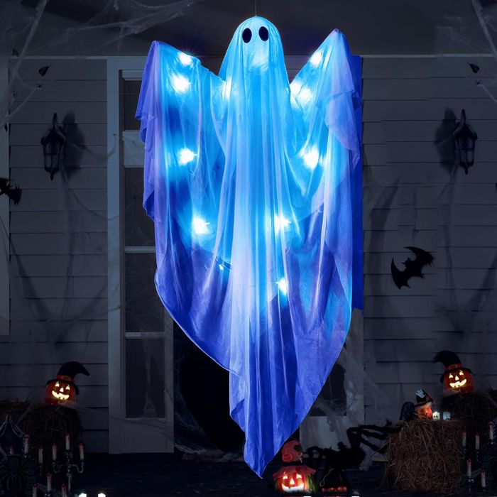 A hanging ghost ornament glowing with blue lights, surrounded by Halloween-themed items like pumpkins and bats. Perfect for Halloween enthusiasts.