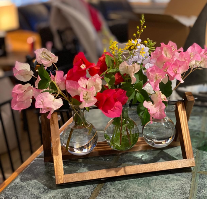 A reviewer's terrarium filled with flower cuttings, creating a lovely natural display.