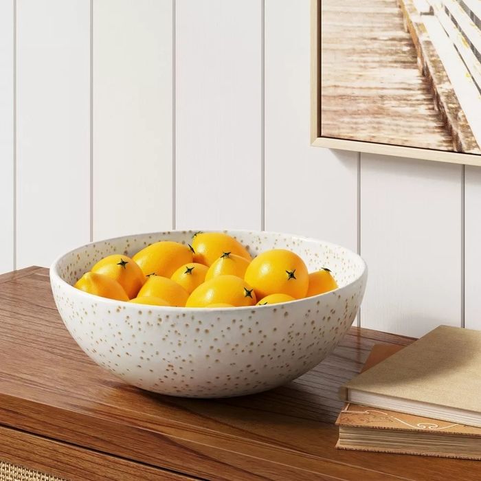 Lemons displayed in a decorative bowl, adding a fresh touch to the room.