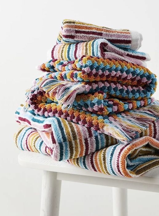 The towel set neatly stacked on a stool