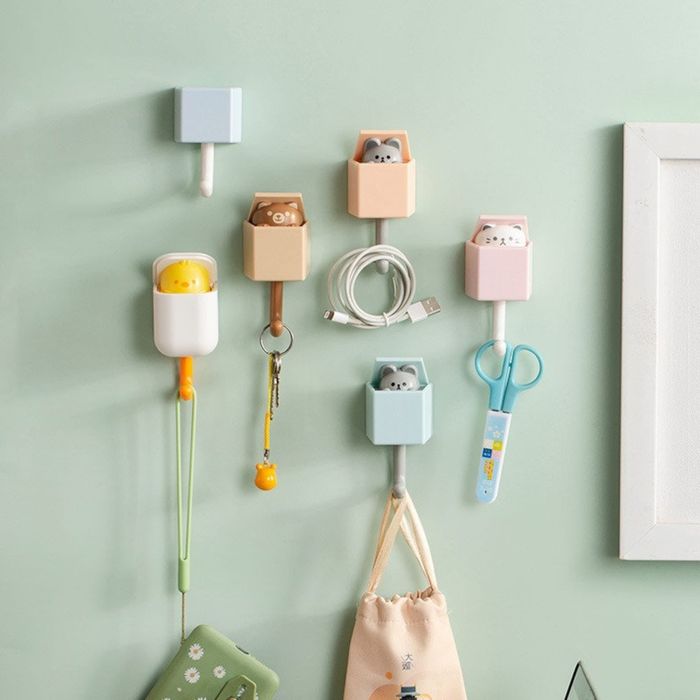 A collection of animal hooks on the wall, each holding various items, adding a fun touch to the space.