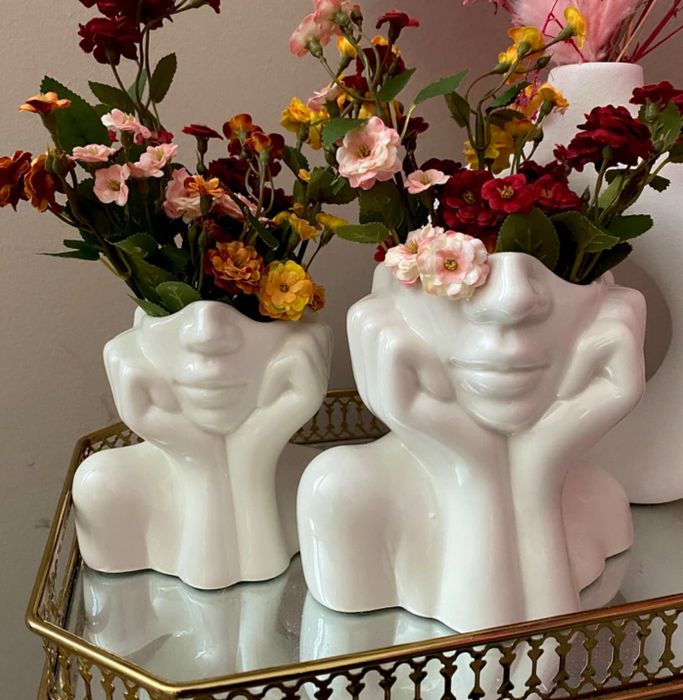 A reviewer's two white ceramic head vases filled with a variety of colorful flowers