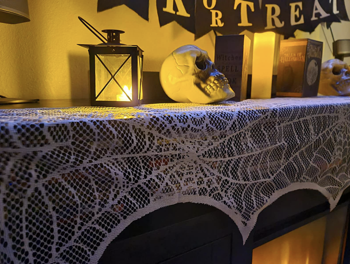 A reviewer’s mantel featuring the white decoration, topped with various Halloween-themed ornaments