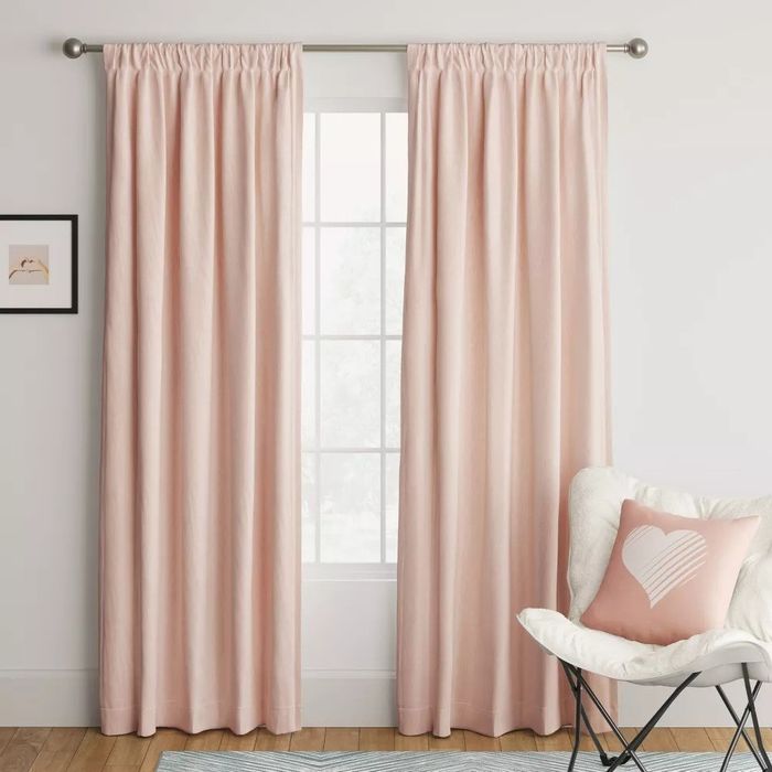 Two heathered curtain panels draped on either side of a window, enhancing the room’s ambiance