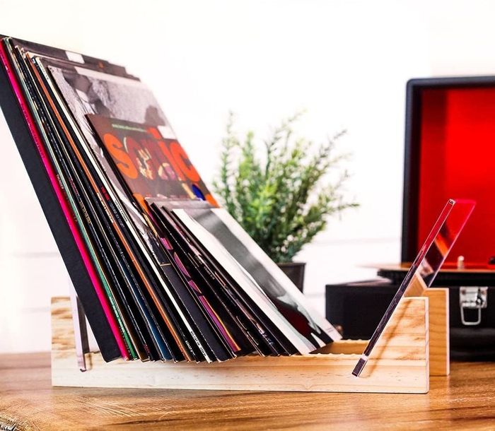 A side shot of the natural wood vinyl holder, showcasing its elegant design and functional organization.