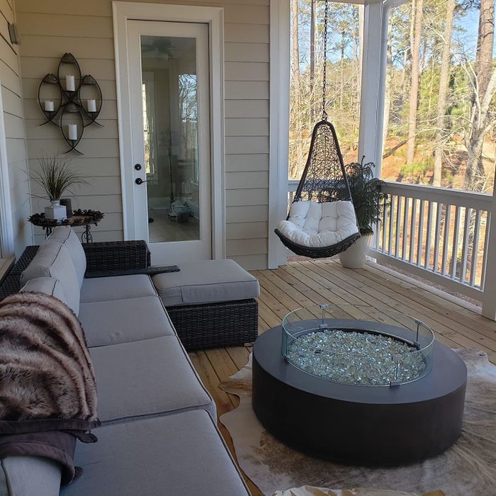 The wicker hanging chair placed on a reviewer's patio, bringing a cozy and whimsical vibe to the outdoors.
