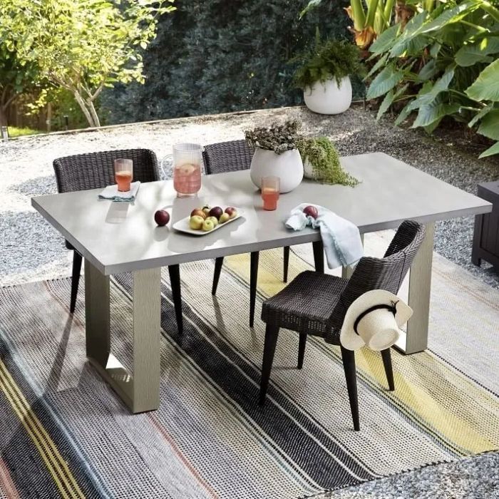 a striped outdoor rug in yellow, grey, and black