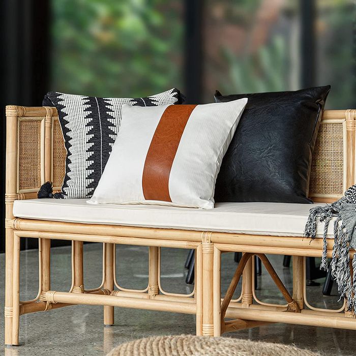 A set of pillows arranged on a bench, adding a cozy touch to the space.