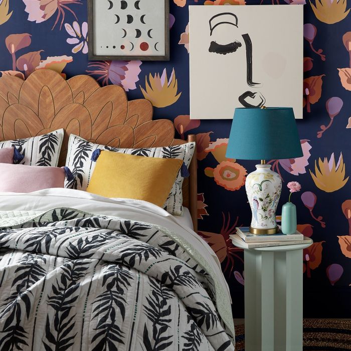 A purple floral peel-and-stick wallpaper adorning the bedroom wall