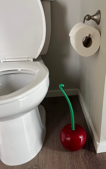 A reviewer's bathroom featuring the cherry toilet brush and holder, giving the space a fun and unique flair.