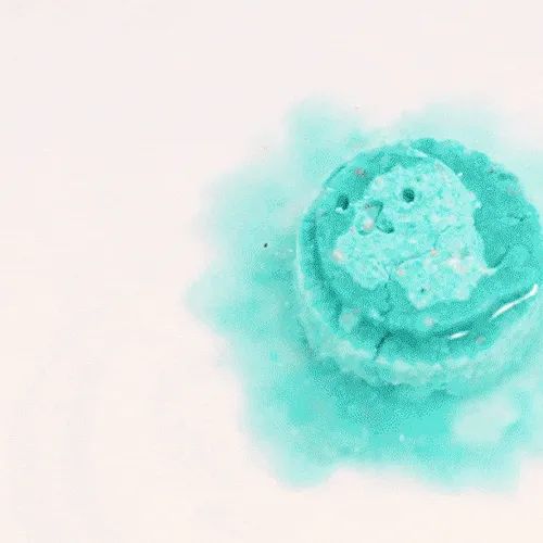 A bath bomb fizzing away in water