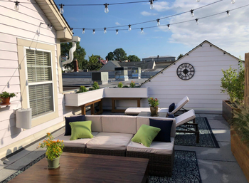 A photo of the clear lightbulbs hanging on a patio during daylight