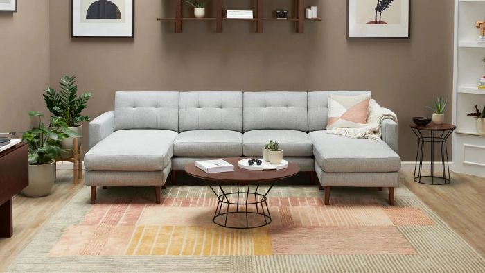 A rug with vibrant stripes in shades of pink, yellow, and brown, offering a playful yet stylish addition to your space.