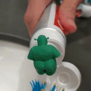 A gif showing toothpaste being squeezed out from Shrek's rear end