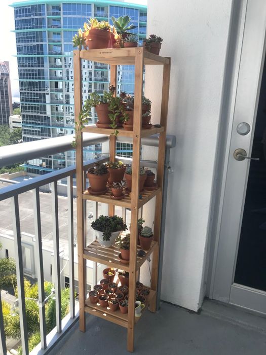 Another reviewer showcasing the same shelf on a balcony, with plants arranged on each level