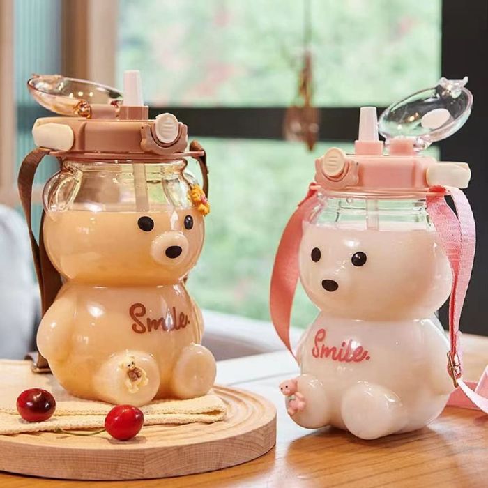 Two water bottles, one with a brown lid and the other with a pink lid