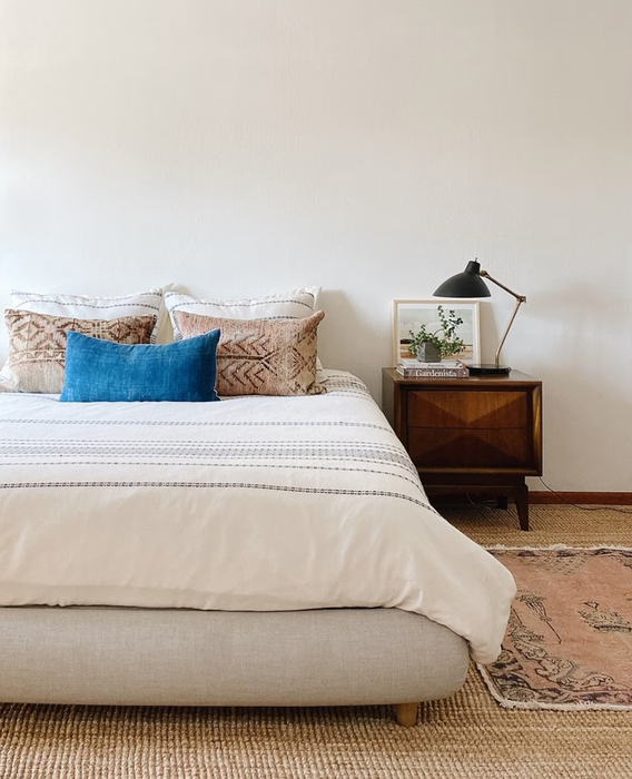 A beige bed frame with a smooth, plush, rounded design that enhances the serenity of the room.