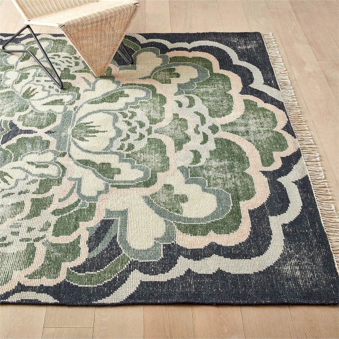 A blue and green floral rug, bringing a vibrant yet calming touch with its beautiful, intricate floral design in shades of blue and green.
